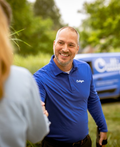 Man using culligan t-shirt with a glass of water