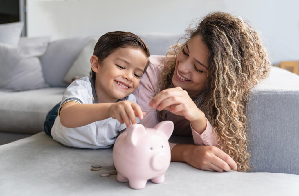 Family Adding Money to Piggy Bank
