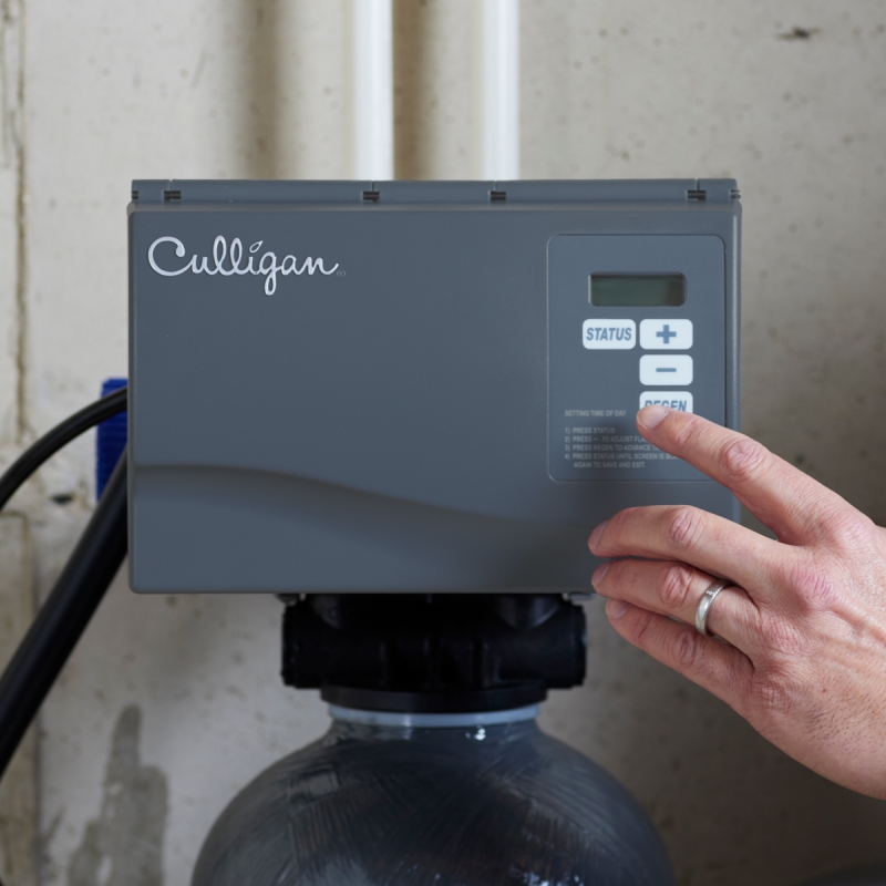 person turning on water softener