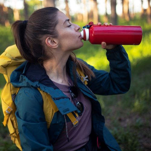 woman drinking from sustainable water bottle