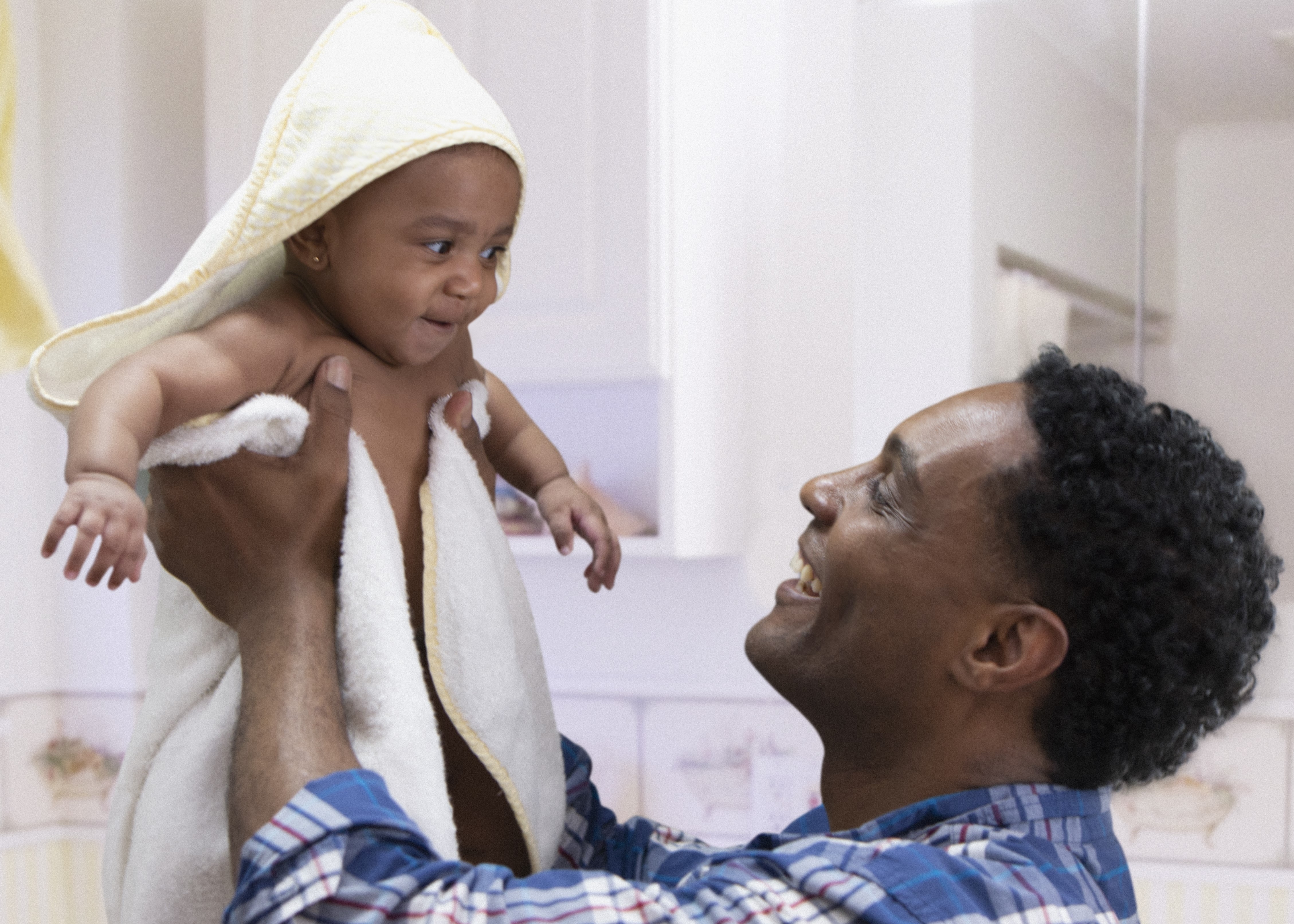 Dad wrapping baby in soft towel washed in soft water