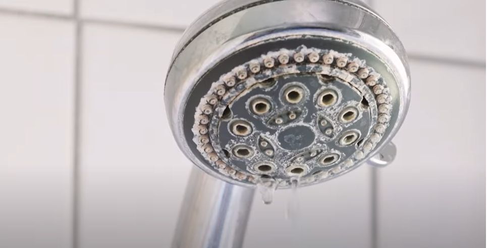 slow showerhead flow from hard well water