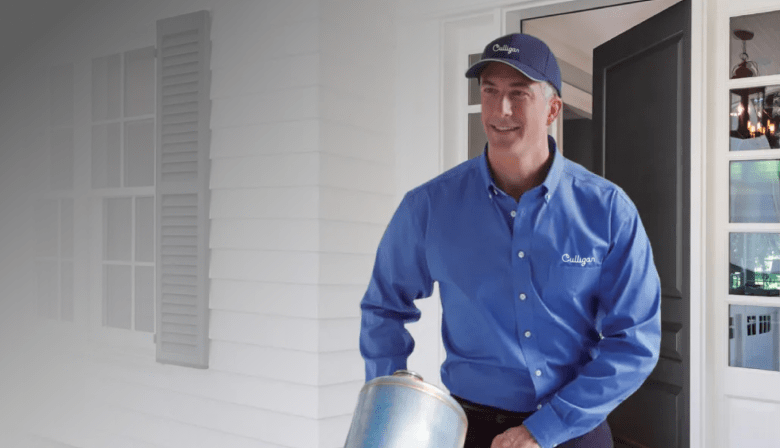 Culligan delivery man delivering portable exchange soft water tank