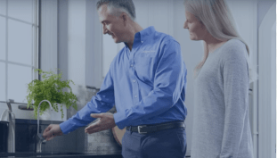 culligan employee showing a woman how a faucet works