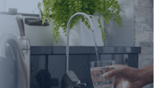 water coming out of faucet into glass